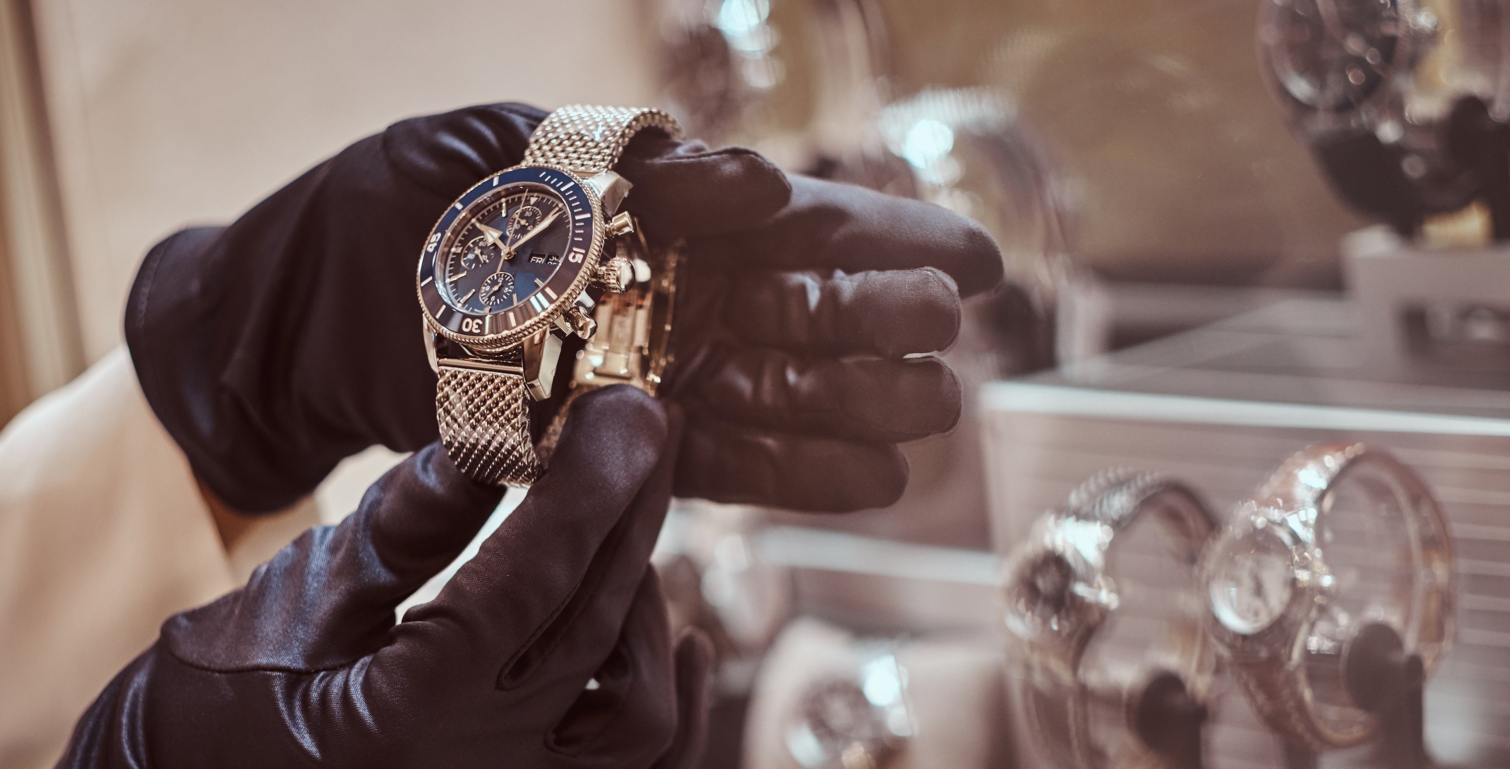 Gloved hands inspecting a luxury Breitling dive watch in a Richmond pawn shop specializing in buying, selling, and collateral loans on high-end timepieces.