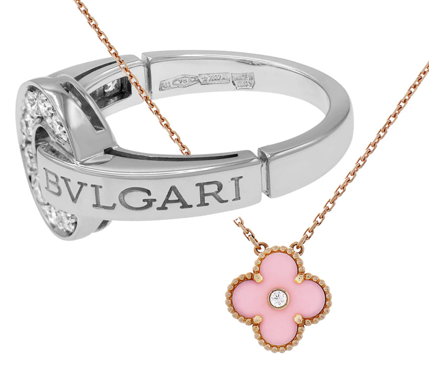 Bvlgari silver bracelet with logo and diamonds, paired with a Van Cleef & Arpels pink enamel clover pendant necklace in rose gold.